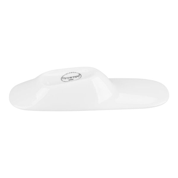 A white, glossy porcelain spoon with a raised center and a flat, elongated shape.
