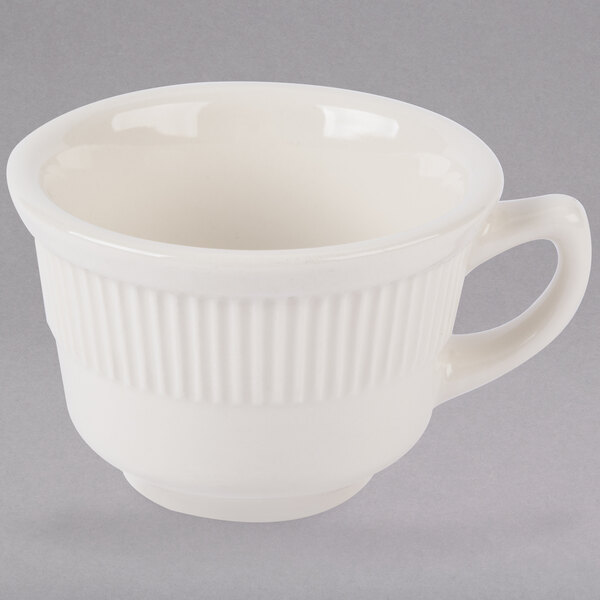 A white Tuxton Hampshire china cup with a handle.