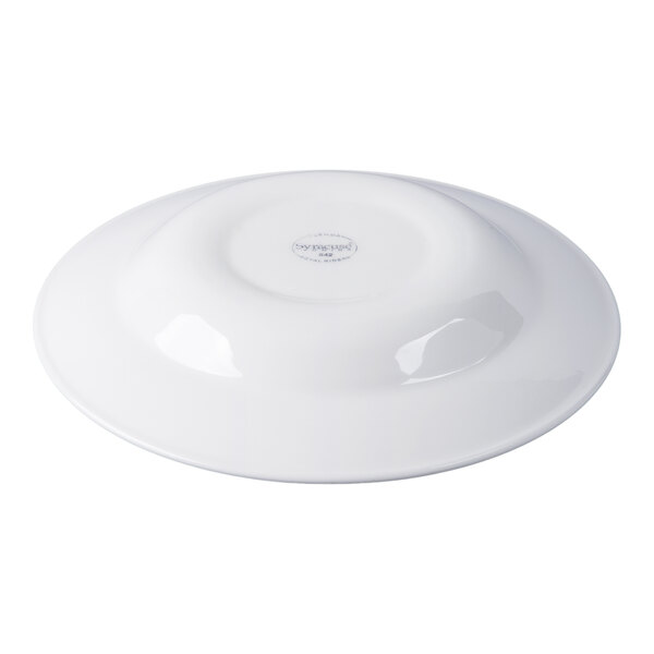 A white round porcelain entree and pasta bowl shown upside down.