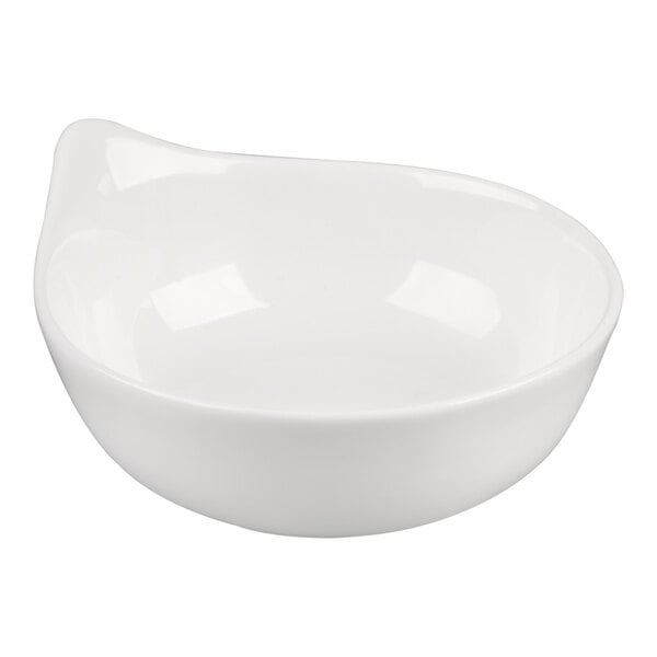 A white porcelain bowl with a smooth, rounded shape and a slightly flared rim on one side.