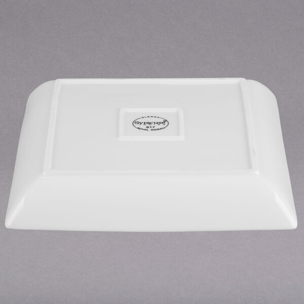 A white square Libbey porcelain coupe plate with a logo on it.