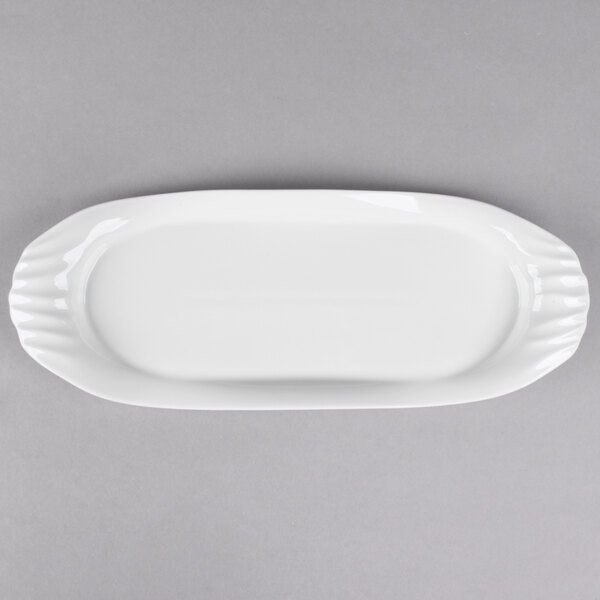 A white rectangular platter with a scalloped edge.