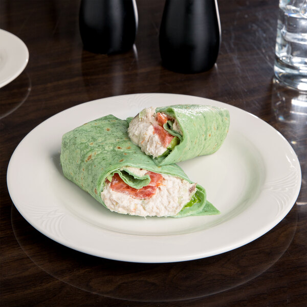 A white porcelain plate with food on it.