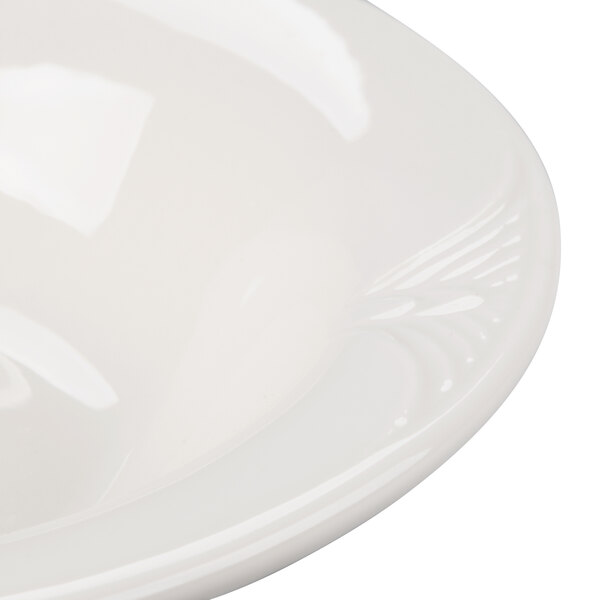 A white porcelain fruit bowl with a white rim.