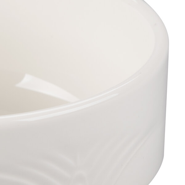A close up of a white Reserve by Libbey Royal Rideau porcelain bouillon bowl with a white rim.