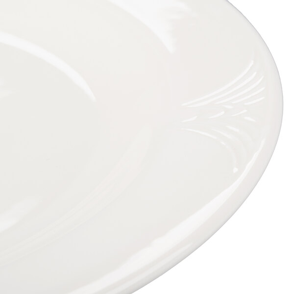A close up of a white Reserve by Libbey Royal Rideau porcelain plate with a decorative design on the rim.