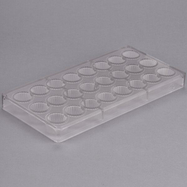 A clear plastic Chocolate World mold with 24 cup compartments.
