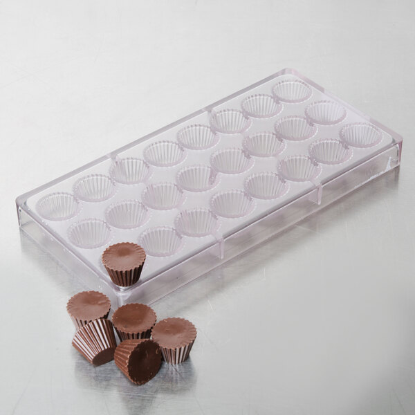 A clear plastic Chocolate World chocolate mold tray with chocolate cups.