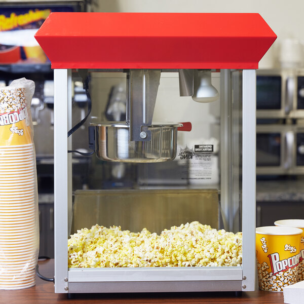 A Satco rough service light bulb in a yellow container with white text and popcorn on it.