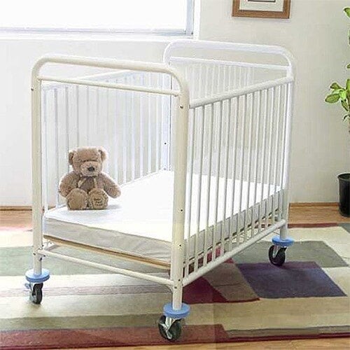 A L.A. Baby Condo window crib with a teddy bear sitting inside.