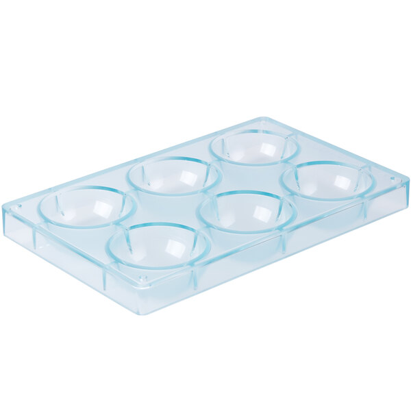 A clear plastic container with six half spheres with a blue border.
