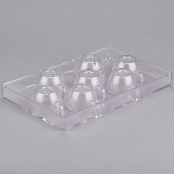 A clear plastic container with circles that have a Martellato expresso cup design.