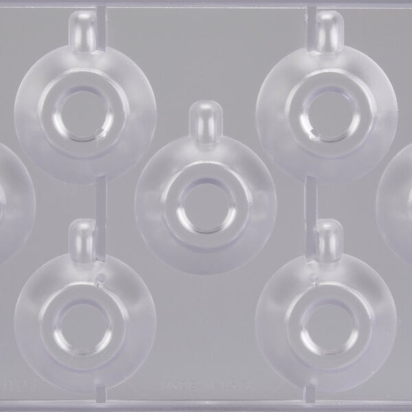 A clear plastic Martellato chocolate mold with 7 espresso cup compartments.