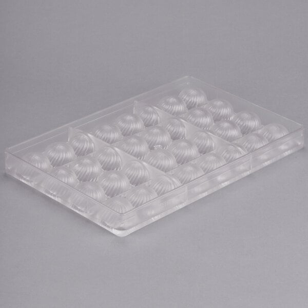 A clear plastic Chocolate World mold with round shapes.