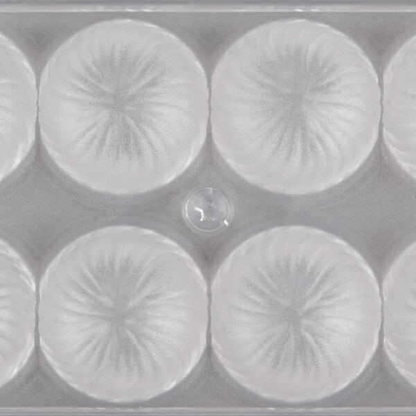 A clear plastic container with circular designs.