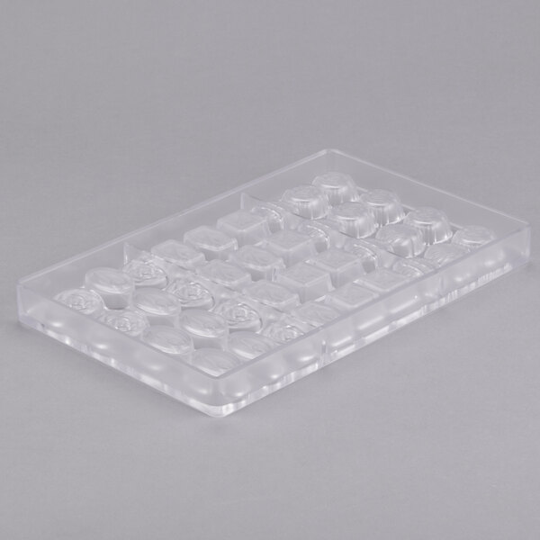 A clear plastic tray with round and variously shaped compartments.