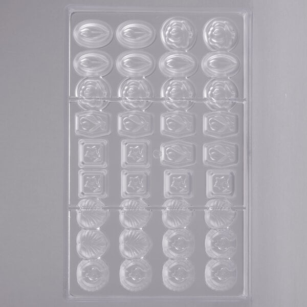 A clear plastic Matfer Bourgeat chocolate mold with various shapes and designs.