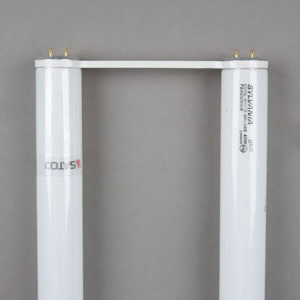 A pair of white u-bend tubes with gold metal bases.