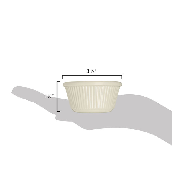 A hand holding a Carlisle fluted white ramekin.