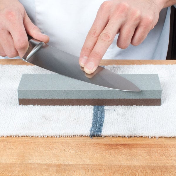 Sharpening stone on a towel being used by a chef