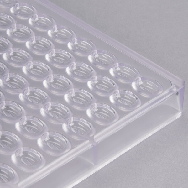 A clear plastic tray with circles.