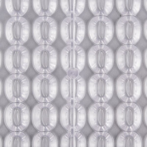 A close up of a plastic surface with 104 compartments.