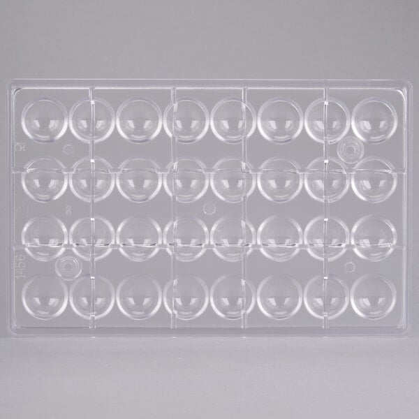 A clear plastic container with many round bubbles, each with a flat side.