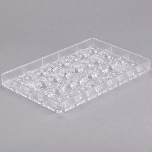 A clear plastic tray with 32 half spheres.