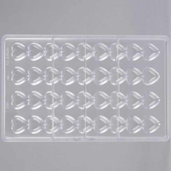A clear plastic Matfer Bourgeat chocolate mold tray with heart-shaped compartments.