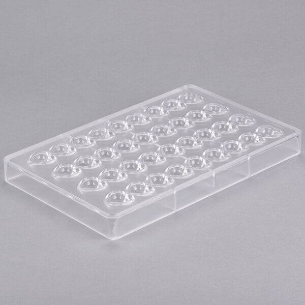 A clear plastic Matfer Bourgeat chocolate mold tray with heart-shaped holes.