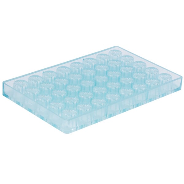 A clear plastic Matfer Bourgeat chocolate mold tray with small circles in it.