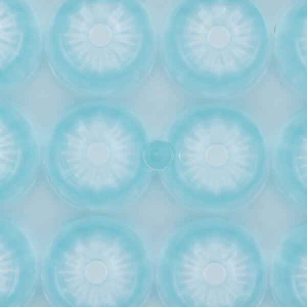A close up of a blue plastic Matfer Bourgeat chocolate mold with circles.