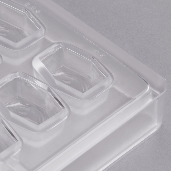 A clear plastic Matfer Bourgeat chocolate mold with rectangular holes.