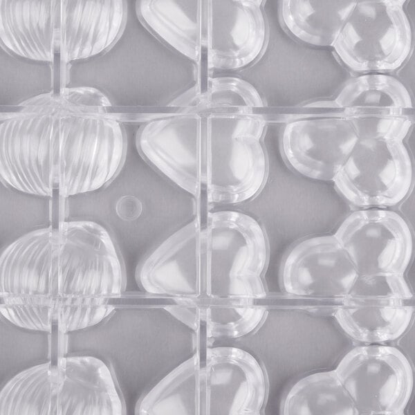 A clear plastic tray with heart shaped and flower shaped compartments.