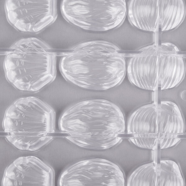 A clear plastic container with Matfer Bourgeat chocolate shells inside.