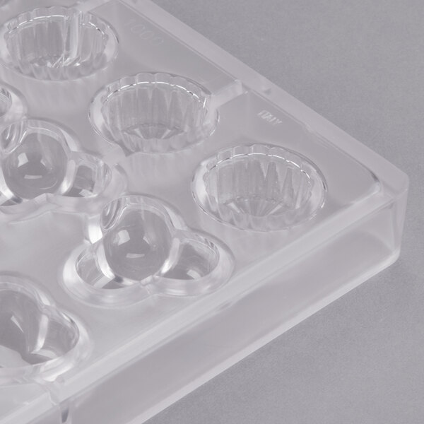 A clear plastic Matfer Bourgeat chocolate mold with 24 compartments.