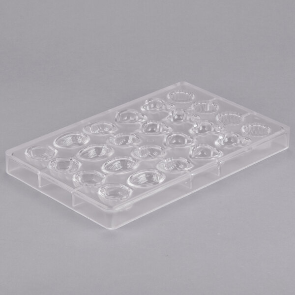 A clear plastic Matfer Bourgeat chocolate mold tray with 24 compartments.