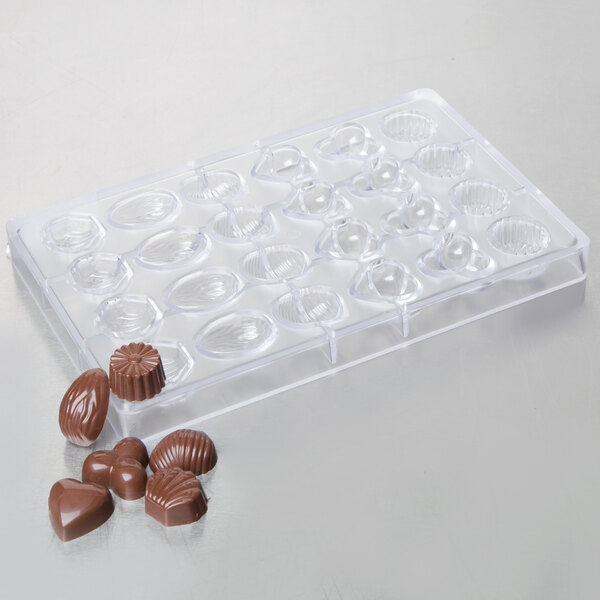 A clear plastic Matfer Bourgeat chocolate mold with heart-shaped chocolates.
