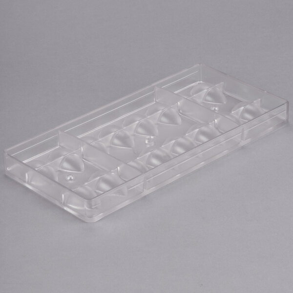 A clear plastic Chocolate World quenelle chocolate mold with 16 compartments.