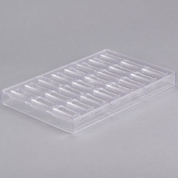 A clear polycarbonate tray with rectangular compartments.