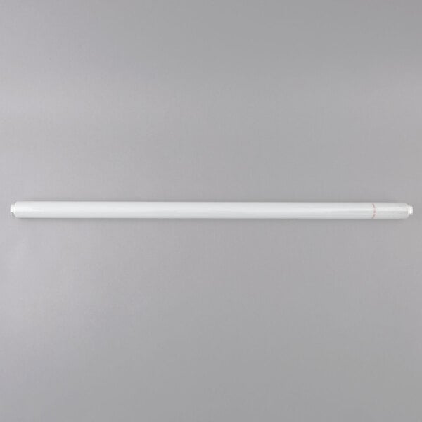 A Satco shatterproof white tube light bulb on a grey surface.