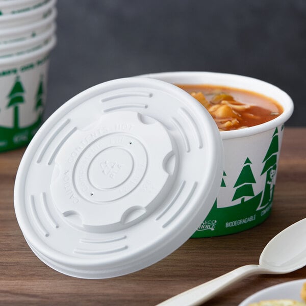 A white EcoChoice PLA compostable plastic lid on a container of food.