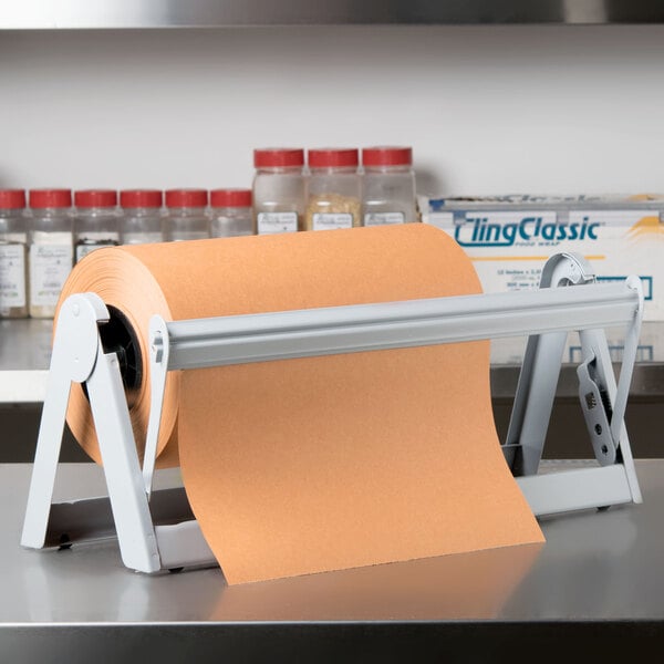 A Bulman gray steel paper dispenser holding a roll of brown paper on a metal rack.