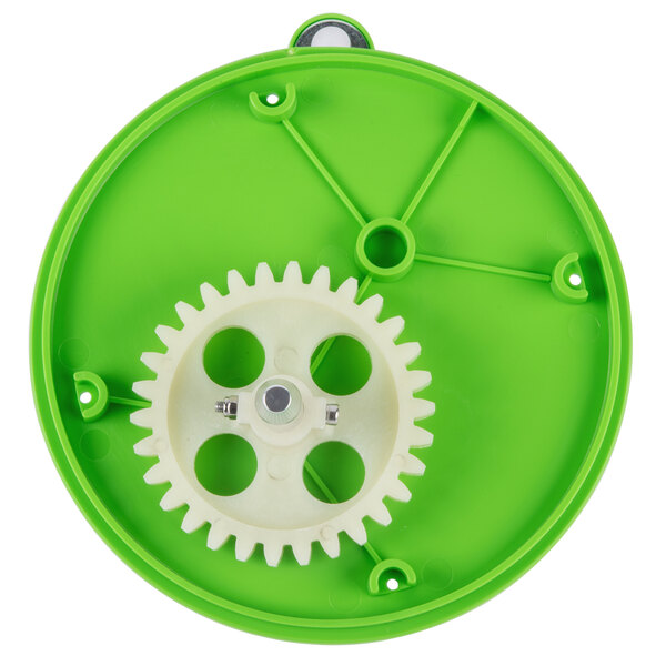 A green plastic toy with a white gear on it.