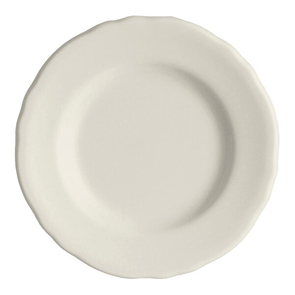 An ivory-colored plate with a scalloped edge.