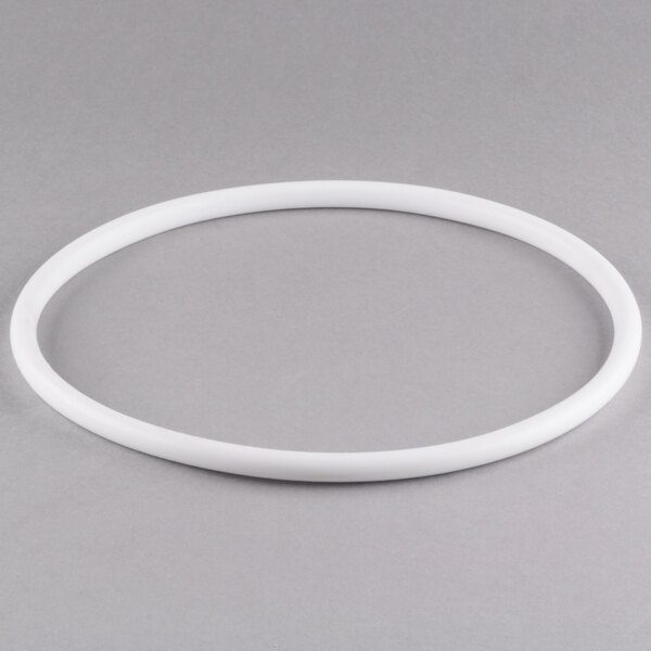 A white plastic gasket with a white circle.