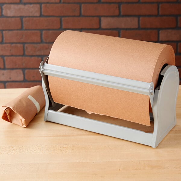 A roll of brown paper on a gray steel paper dispenser.