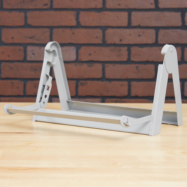 A gray Bulman steel paper dispenser on a table.