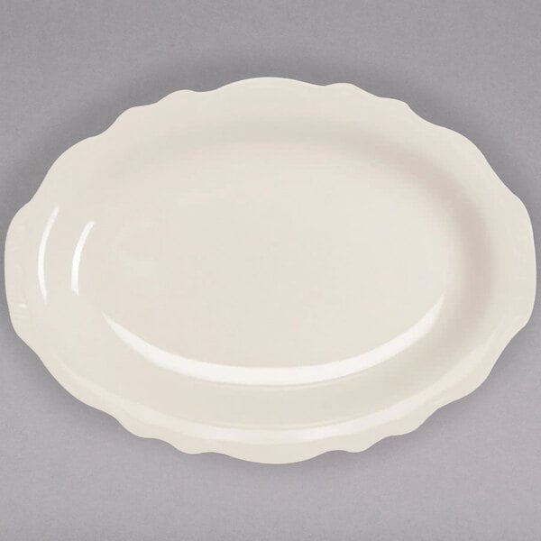 An ivory oval platter with a scalloped edge.