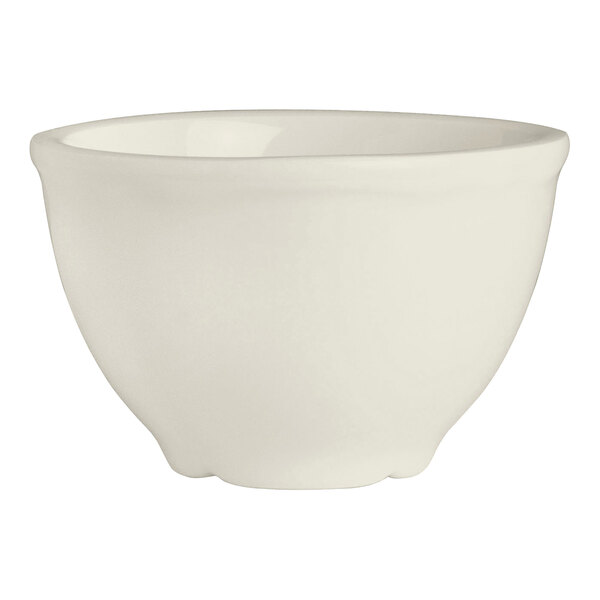 A small ivory-colored bouillon bowl with a scalloped edge.